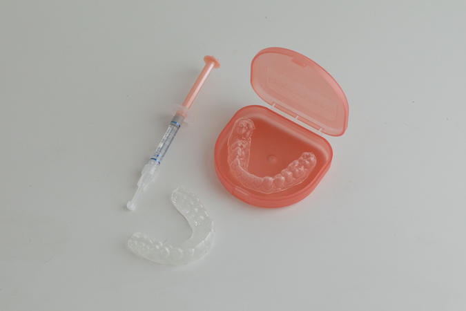 Custom bleach trays hold whitening gel evenly against the teeth for safe and effective at-home whitening.
